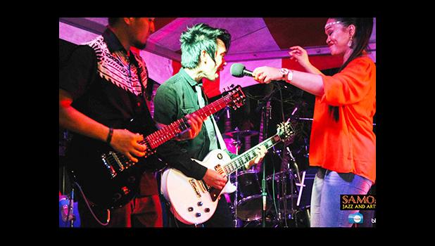 Seen here, American Samoa songstress Jonitta Fruean shares the mic with an up and coming young Filipino band, Cuerdo. Speaking of the experience, Jonitta said, "We were truly honored to have participated in the Samoana Jazz Fest. It's not often we musicians get these opportunities to relieve our hunger for melodical tones and beautiful rhythms here on our Islands. This was definitely a treat."   [courtesy photo]