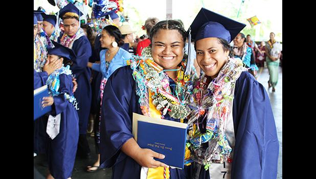 Two graduates of Kanana Fou High School smile proudly for the camera at the end of the commencement ceremony yesterday that was held at the CCCAS Taeaoafua Gymnasium. Congrats girls!   [photo:EM]