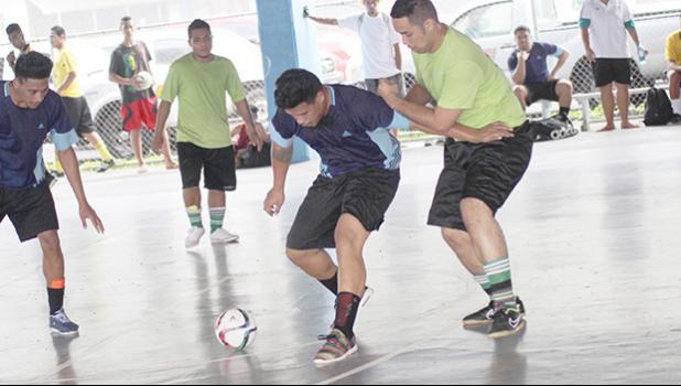 Tafuna Jets 1’s Harry Matau holds off Lion Heart B’s Charmaney Faatupuinati on Match Day 3 of the 2017 FFAS Futsal Tournament at Samoana High School’s gym in Utulei on Saturday, May 20, 2017.   [FFAS MEDIA/Brian Vitolio]