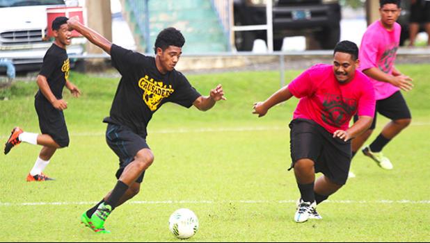 Tavita Talaga, (left) of Nu’uuli Voc-Tech in action against the Leone Lions in an ASHSAA Boys’ varsity soccer game on Monday, March 26, 2018 at Pago Park Soccer Stadium.  [FFAS MEDIA/Brian Vitolio]