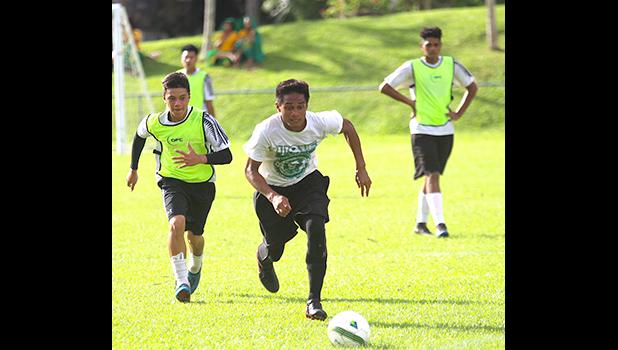 A Leone Lions’ striker races a Samoana defender one-on-one to score a goal during an ASHSAA Boys Soccer JV game on April 20, 2018 at Pago Park Soccer Stadium.  [FFAS MEDIA/Brian Vitolio]