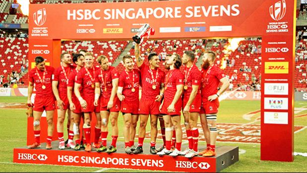 Canada 7s player, Mike Fuailefau proudly raises the HSBC Singapore 7s Cup after his team defeated the USA Eagles 6-19 at the Singapore HSBC Sevens, Day 2, National Stadium, Singapore.  [Photo: Barry Markowitz]