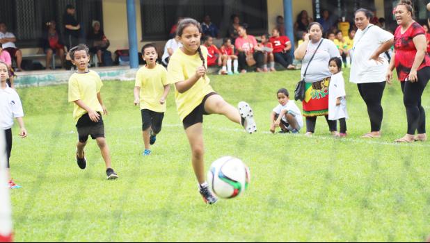 A player of the Pago Youth mixed 7-9 age group shoots and scores a goal on July 4, 2017 during opening day of the FFAS Summer Youth League at Pago Park Soccer Stadium.  [FFAS MEDIA/Brian Vitolio]