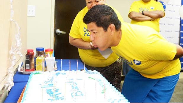 Former Bluesky Communications CEO and President, Adolfo Montenegro in a Samoa News file photo blowing out the candles on the Bluesky birthday cake, in celebration of their company’s 16 years of service to the people of American Samoa, in July 2015. [photo: SN file / TG]