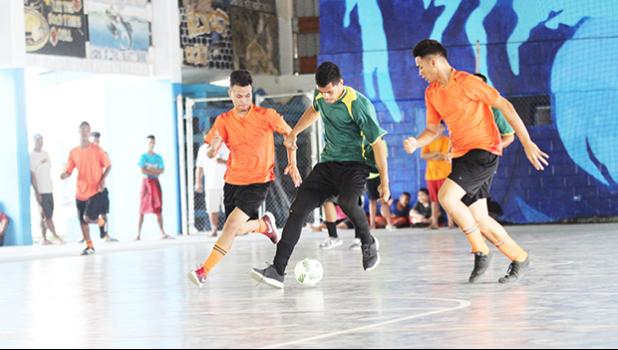 Ne’emia Kaleopa of Utulei Youth (middle) controls the ball against Royal Puma’s Willie Malele (right) and TJ Tauamo (left) during their 2017 Futsal Tournament’s pool game at Samoana High School’s gymnasium on Saturday, May 6, 2017.  [FFAS MEDIA/Brian Vitolio]
