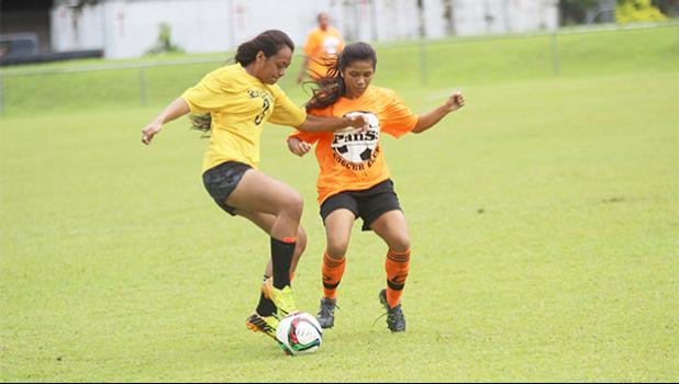 Lei Amisone, left, of Pago Youth defends against PanSa’s striker Maricar Parungo during a game of the women’s 2017 FFAS National League on Saturday, Sept. 23 at Pago Park Soccer Stadium.   [FFAS MEDIA/Brian Vitolio]