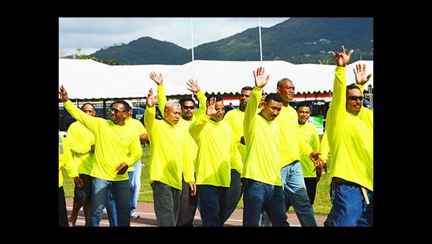 Paramount Builders Inc., workforce marches Friday during the ASG Workforce Day ceremony at Veterans Memorial Stadium in Tafuna. [photo: AF]
