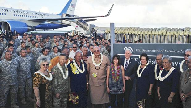 Vice President Mike Pence stands with his wife Karen as they pose for a photo with officials and U.S. service members during a refueling stop in Pago Pago, American Samoa, Monday, April 24, 2017. Pence stopped in American Samoa after leaving Australia en route to Hawaii. (AP Photo/Ken Thomas)