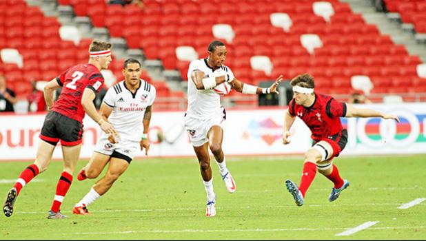 USA scoring star, Perry Baker, demonstrates his Heisman Trophy form enroute to a try as the USA Eagles devastated Wales 35-19 at the Singapore Sevens, Day 1, National Stadium, Singapore.  [Photo: Barry Markowitz]