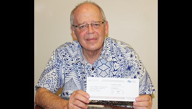 Territorial Bank of American Samoa president Philip Ware shares with reporters from local media the “Official Notice of Routing Number Assignment” issued to TBAS by the American Bankers Association, during an interview Wednesday. Ware plans to put the notice in a picture frame and display it in the bank’s lobby for all to see.  [photo: FS]