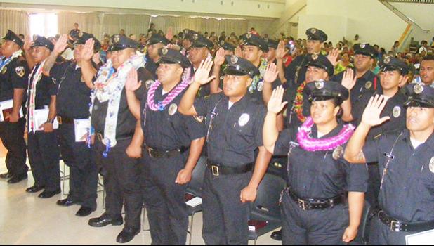 A look at some of the officers as the take the oath of office, as sworn in officers, during Friday’s 25th Police Academy graduation ceremony at Gov. Rex Lee Auditorium. [photo: Fili Sagapolutele]