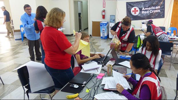 American Red Cross officials and volunteers from the US working with local Red Cross volunteers yesterday at the Tafuna office, before disaster teams head out to the field. [photo: Leua Aiono Frost]