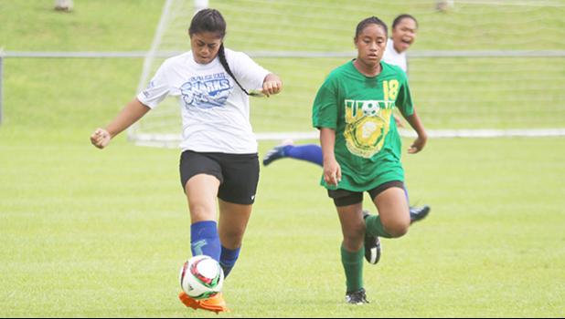 A Samoana Sharks varsity defender clears the ball against a Leone Lions attacker during an ASHSAA Girls Soccer game on Saturday, Jan. 21, 2017 at Pago Park Soccer Stadium in Pago Pago.  [FFAS MEDIA/Brian Vitolio]