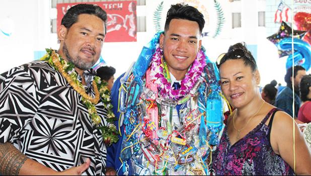 Shark Jerold Papu and his proud parents from Fagatogo at his graduation yesterday morning for the Class of 2017 — Home of the Mighty Sharks.  [photo:EM]