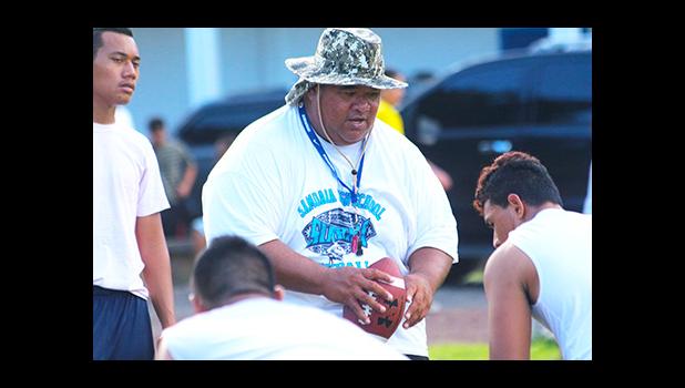 Samoana Sharks Defensive Coordinator, Maselino Tautu keeping a close eye on his defensive unit during practice yesterday evening at their school field. [photo: TG]