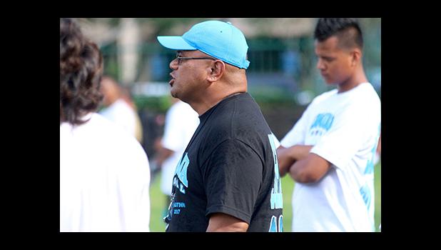 Samoana High School Head Football Coach Pati Pati calling out plays for his offense, during practice yesterday evening — they will face the Warriors tomorrow after Nu'uuli and Leone's double header match ups. [photo: TG]
