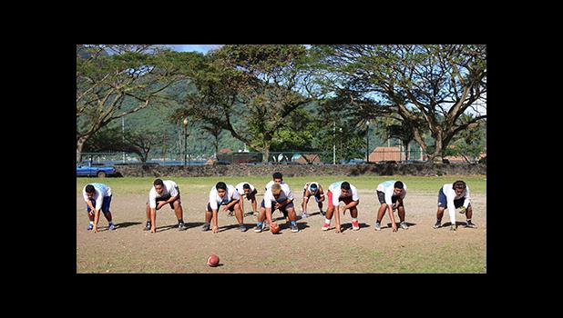 Samoana Sharks Varsity offensive unit — in a full house formation — as they rehearsed their running attack during yesterday’s practice at their school field. [photo: TG]