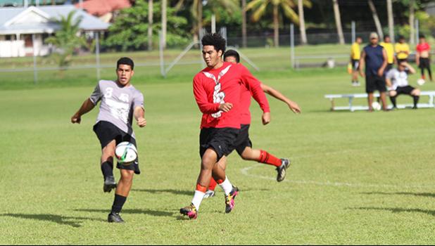 A Dolphins defender clears the ball away from danger before a Faga’itua opponent can get to it during their ASHSAA Boys’ varsity soccer playoff game on April 29, 2017 at Pago Park Soccer Stadium. SPA won 3-2.  [FFAS MEDIA/Brian Vitolio]