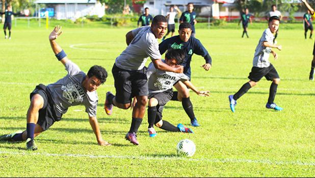 South Pacific Academy defenders scramble to clear a ball away from a dangerous opportunity to their Iakina opponents during an ASHSAA Boys’ varsity soccer game on Wednesday, March 28, 2018 at Pago Park Soccer Stadium.  [FFAS MEDIA/Brian Vitolio]