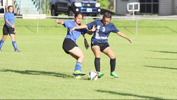 A Samoana player, left, and SPA opponent battle for possession of the ball during a 2016-17 ASHSAA Girls soccer game on Wednesday March 8, 2017 at Pago Park Soccer Stadium.   [FFAS MEDIA/Brian Vitolio]
