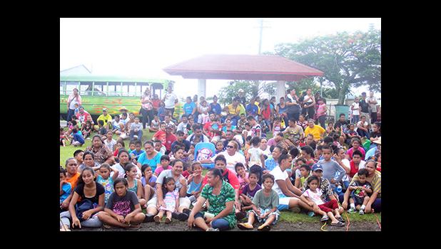 Some of the large number of children, with a few parents, who showed up Monday afternoon for the distribution of Christmas toys from the "Pay It Forward — Toy Drive Project" spearheaded by Tapumanaia Galu Satele Jr., and his children, to ensure that children of the Samoa Tuna Processors employees, who lost their jobs, last Friday, have smiling faces for Christmas.  [photo: FS]