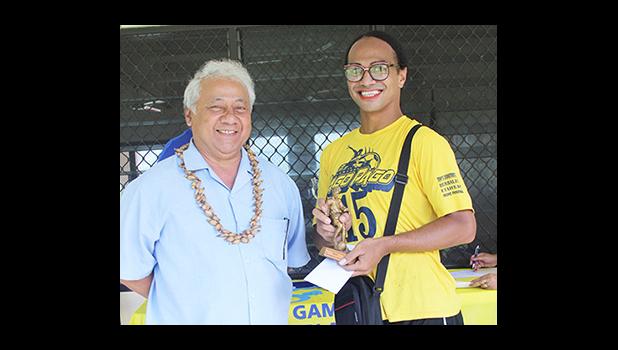 Sam Tualaulelei, a Pago Youth defender, receives his MVP trophy from FFAS President Faiivae Iuli Alex Godinet, left, for the 2016 FFAS National League on Saturday, November 26, 2016.   [FFAS MEDIA/Brian Vitolio]