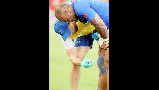 Manu Samoa's Selesele was injured during his outstanding second effort try vs Australia. Samoa's medic was promptly on the scene. Singapore Sevens, Day 1, National Stadium, Singapore.  [Photo: Barry Markowitz]