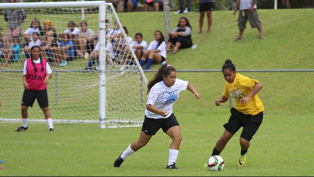 Samoana’s Deidra Steffany defends against a Tafuna Warrior opponent during an ASHSAA varsity girls’ soccer game on Saturday, Feb. 24, 2018 at Pago Park Soccer Stadium.  [FFAS MEDIA/Brian Vitolio]
