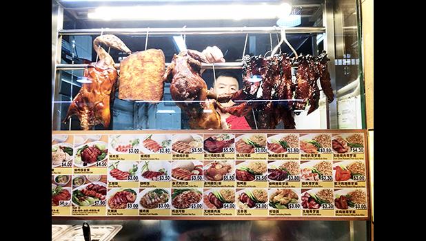 A cook arranges his roast pork, duck and chicken offerings at the Food Loft, Woodlands, Singapore. [photo: Barry Markowitz, 5/1/18]