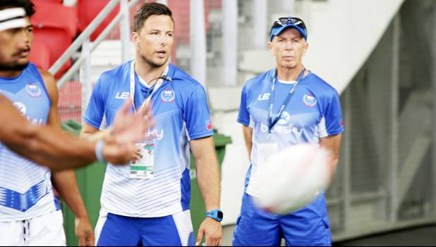 Sir Gordon Tiejtens and his acting trainer son put Manu Samoa through pregame warm ups at the Singapore Sevens, Day 1, National Stadium, Singapore. [Photo: Barry Markowitz]