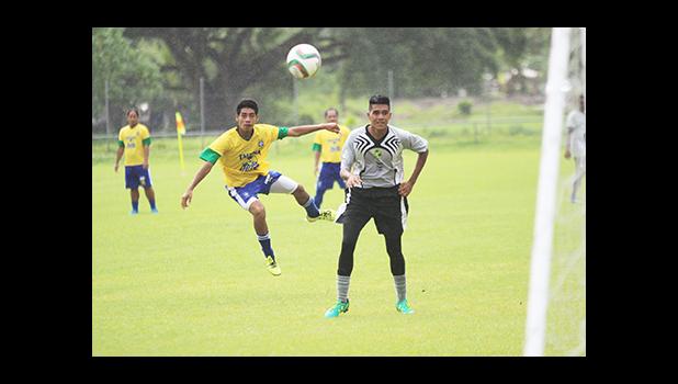 Pouono Samuelu of the Tafuna Jets takes a shot at goal while Utulei Youth’s Tokoita Vaieli looks on in a men’s game on Match Day 12 of the ongoing, 2016 FFAS National League on Saturday, Nov. 12, at Pago Park Soccer Stadium.  [FFAS MEDIA/Brian Vitolio]