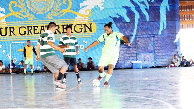 Max Taukilo (right) of Taputimu Youth in action against a Vaiala Tongan opponent during their 2017 Futsal Tournament’s pool game at Samoana High School’s gymnasium on Saturday, May 6, 2017.  [FFAS MEDIA/Brian Vitolio]