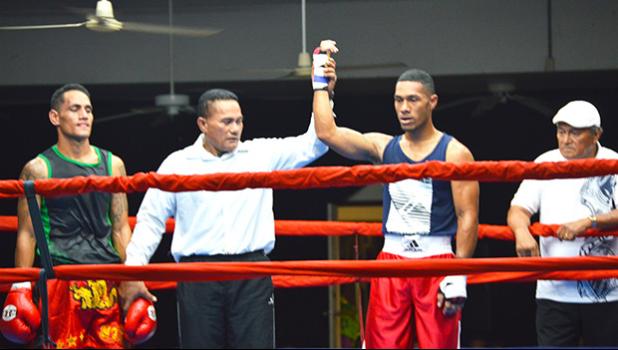 American Samoa raising star, George Tanoa Jr (right) raising his hand after a knockout win over his tough opponent, Tasi Tonelafo (left) of Tumua ma Pule boxing club in the middleweight division during the American Samoa Flag Day 2018 Championship Boxing between the two Samoas last Saturday night at the old Bowling Alley in Tafuna.  [photo by AF]