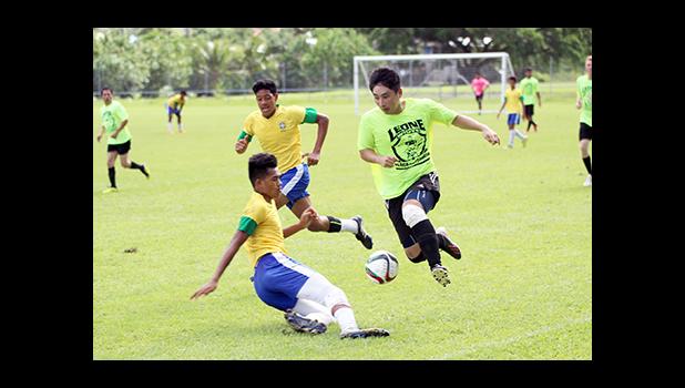 Gun Kang of Ilaoa & To’omata leaps over a Vaiala Tongan defender during their Match Day 9 game of the men’s 2016 FFAS National League at Pago Park Soccer Stadium on Saturday, Oct. 22, 2016. [[FFAS MEDIA/Brian Vitolio]