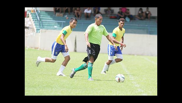 A Lion Heart player dribbles away from Vaiala Tongan opponents on in a men’s game on Match Day 12 of the ongoing, 2016 FFAS National League on Saturday, Nov. 12, at Pago Park Soccer Stadium.  [FFAS MEDIA/Brian Vitolio]