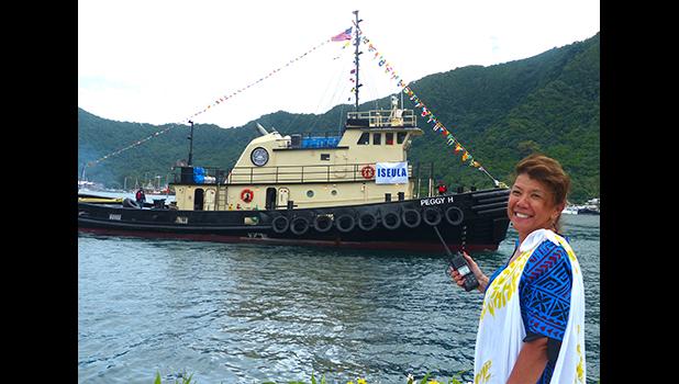 Port Administration director, Taimalelagi Dr. Claire Poumele, posed for a Samoa News photo on the main dock yesterday with Port’s second tugboat, Peggy H, in the waters of Pago Pago Harbor.  The tugboat, will be renamed Iseula and is the second one for the Port Administration as required by US Coast Guard regulations.  [photo: Leua Aiono Frost]