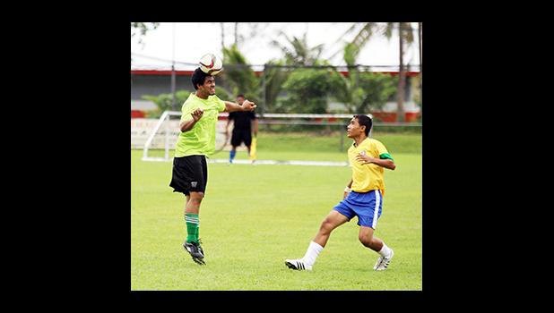 Uasi Heleta, left, of Lion Heart heads the ball away from Vaiala Tongan opponent Misi Musu during a men’s game on Match Day 4 of the 2016 FFAS National League on Saturday, Sept. 10, at Pago Park Soccer Stadium.   [FFAS MEDIA/Brian Vitolio]