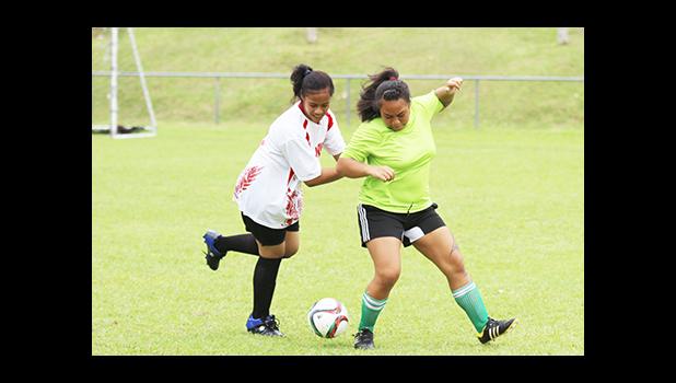 A Vaiala Tongan player (left) and Lion Heart opponent fight for possession of the ball during a women’s game on Match Day 5 of the 2016 FFAS National League on Saturday, Sept. 17, at Pago Park Soccer Stadium.  [FFAS MEDIA/Brian Vitolio] 