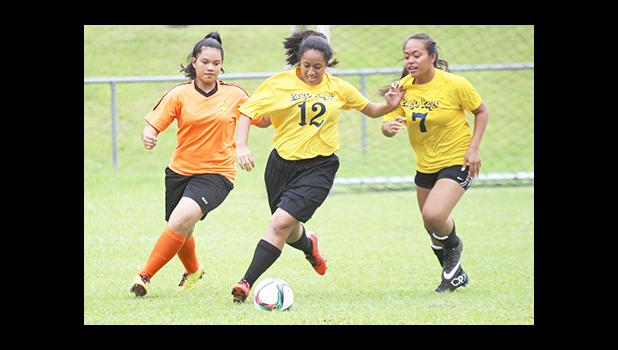 Two Pago Youth defenders (right) in action against an Utulei Youth during a women’s game on Match Day 5 of the 2016 FFAS National League on Saturday, Sept. 17, at Pago Park Soccer Stadium.  [FFAS MEDIA/Brian Vitolio] 