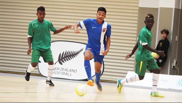 Walter Pati of American Samoa dribbles away from two Solomon Islands’ opponents during a game of the OFC Youth Futsal Tournament at Bruce Pulman Arena in Auckland, New Zealand on Wednesday, October 4, 2017.  [FFAS MEDIA/Brian Vitolio]