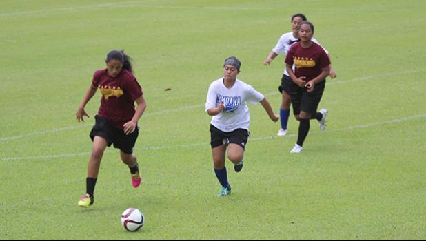 Destiny Kapisi of Tafuna (left) in action against the Samoana Sharks during an ASHSAA J-V girls’ soccer game on Saturday, Feb. 24, 2018 at Pago Park Soccer Stadium.  [FFAS MEDIA/Brian Vitolio]