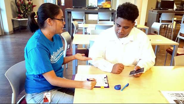 ASCC Admissions Outreach Counselor, Katrina Garcia-Helsham helps prospective student Lauama Pese