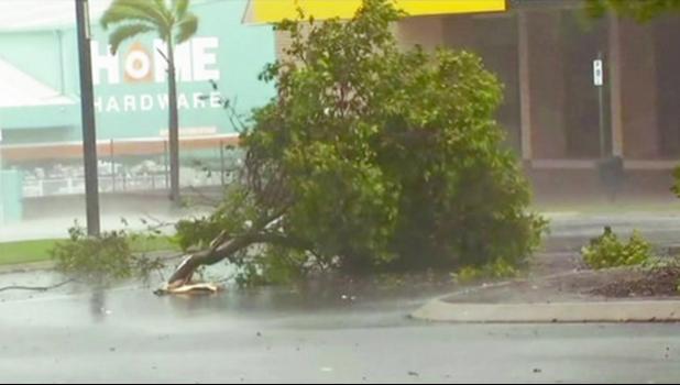 In this image made from video, tree debris lies on the street as wind gusts in Bowen, eastern Australia, Tuesday, March 28, 2017.  A powerful cyclone lashed islands, damaged roofs and cut power on Tuesday as it edged toward Australia's tropical northeast coast, officials said.(AuBC via AP)