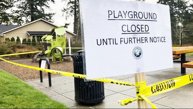 Police caution tape surrounds a playground in Lake Oswego, Ore.