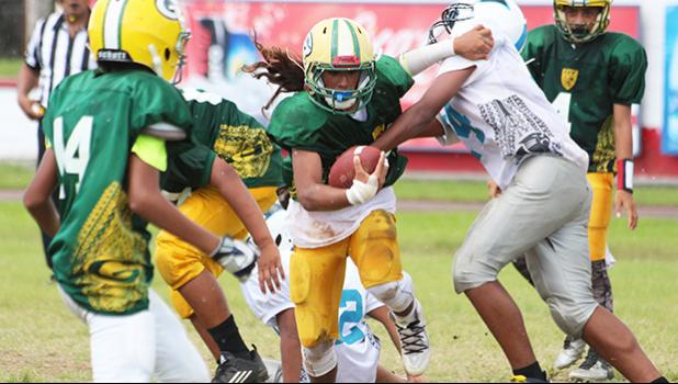 Wylan Faga of the AYFS Packers breaking tackles through midfield and out towards the open field to score his second touchdown of the game in the second quarter of their match up against the AYFS Panthers. Faga led the Packers in their 32 - 6 victory. [photo: TG]
