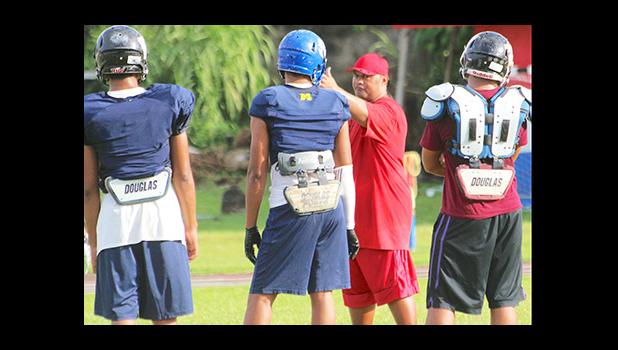All-Star Linebacker coach Merton Hunkin of Faga’itua High School working with his backs, during practice this past Tuesday. [photo: TG]