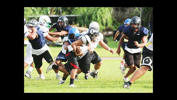 (FHS) Blessman Ta’ala immediately apprehends ball carrier, (THS) Andrew Toilolo, behind the line of scrimmage during an All-Star practice session.  [photo: TG]