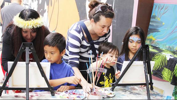 Artist Lureen Cascara helps Koa Kaeka Baptista, 9, with his painting while Michelle Florido helps her son Tristan, 3, and Corinne Ebias, 9, with their painting during the Aloha Festival at the Napa Valley Expo on Saturday. [Maria Sestet, Napa Valley Register]