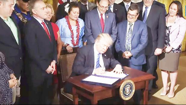  Flanked by Members of Congress and Secretary Shulkin, including Congresswoman Amata,  President Trump signs the Department of Veterans Affairs Accountability and Whistleblower Protection Act into law. [courtesy photo]