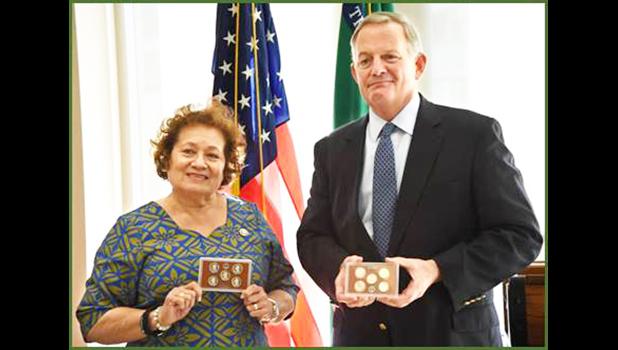 Cong. Aumua Amata with coins and Director David J. Ryder